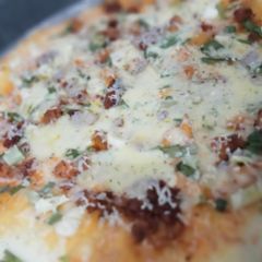 A picture of Chicken tikka pizza.