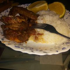 A picture of Boiled rice with fried chicken.