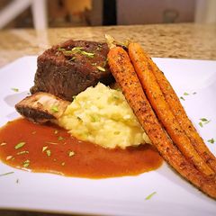 A picture of Braised short rib with horseradish whipped potatoes and roasted carrots.