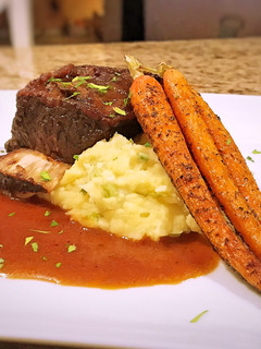 A picture of Braised short rib with horseradish whipped potatoes and roasted carrots.