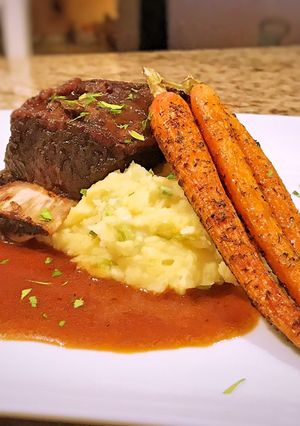 A picture of Braised short rib with horseradish whipped potatoes and roasted carrots.