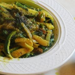 A picture of Zucchini noodles with spinach masala curry.