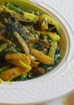 A picture of Zucchini noodles with spinach masala curry.