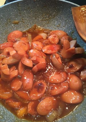 A picture of Sweet and Sour sausage with onion.