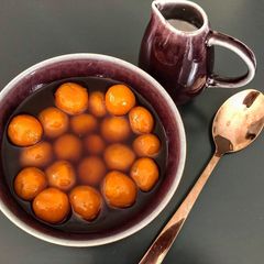 A picture of Kolak Biji Salak - Sweet potato balls in palm sugar syrup and coconut milk.