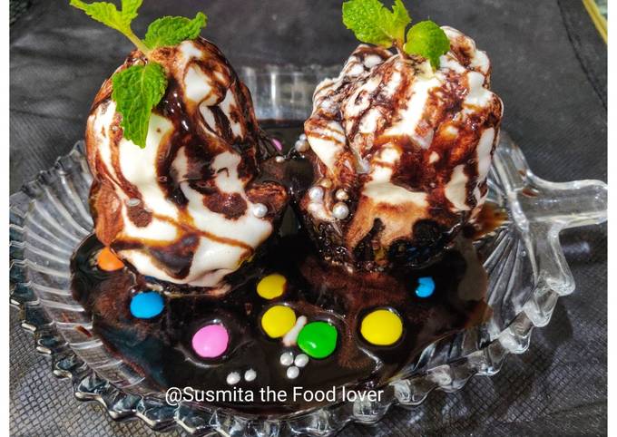Chocolate cupcakes loaded with ice cream and chocolate sauce