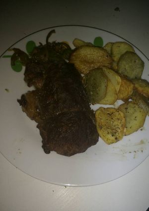 Una foto de Carne al horno con papas y batatas fritas