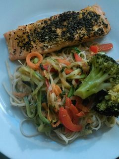 Una foto de Salmón con naranja y basilico en papillote con fideos chinos salteados con verduras