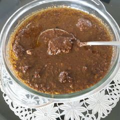 A picture of Chicken in walnut pomegranate gravy(fesenjan).