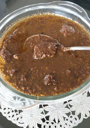 A picture of Chicken in walnut pomegranate gravy(fesenjan).