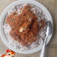 A picture of Rice and beans with fish stew.