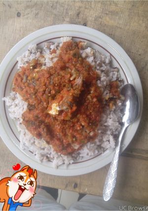 A picture of Rice and beans with fish stew.