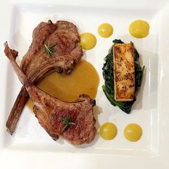A picture of Lamb chop with Corn puree, celeriac fondant, spinach and mushroom sauce.
