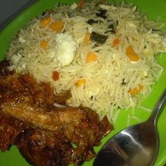 A picture of Chinese rice with chicken souce.