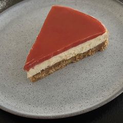 A picture of Lemon cheesecake with tomato jelly topping.