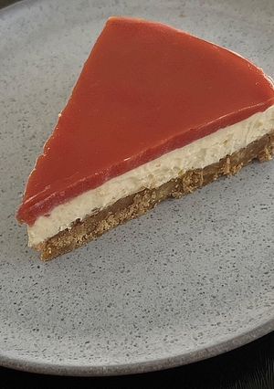 A picture of Lemon cheesecake with tomato jelly topping.
