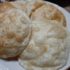 A picture of Poori with mangrela and ajwain beneficial remedy at home.