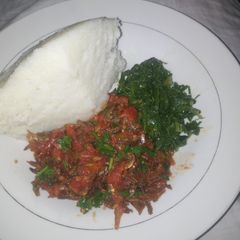 A picture of Fried Omena Sukuma wiki and ugali.