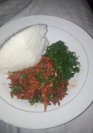 A picture of Fried Omena Sukuma wiki and ugali.