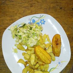 A picture of Fried irish potatoes and plantain with stir fry veggies.