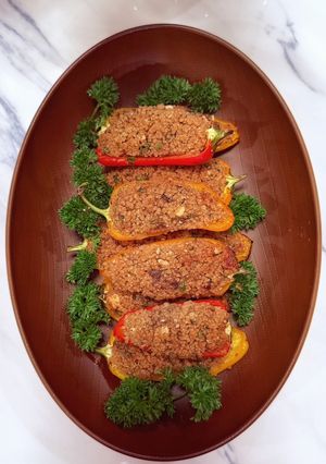 A picture of Stuffed baby peppers with date couscous and feta.