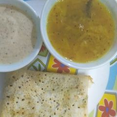 A picture of Dosa sambhar and chutney.