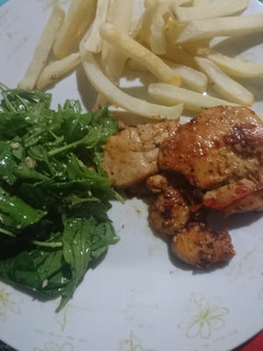 Una foto de Presas De Pollo Con Rúcula Y Papas Fritas