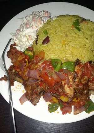 A picture of Fried rice,pepper chicken and salad.