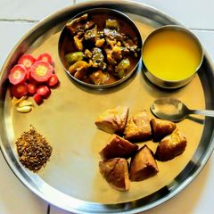 A picture of Bafle and brinjal curry.