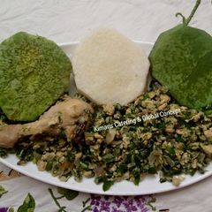 A picture of Green veggies sauce with boiled yam.