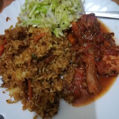 A picture of Chicken curry with stir fry rice.