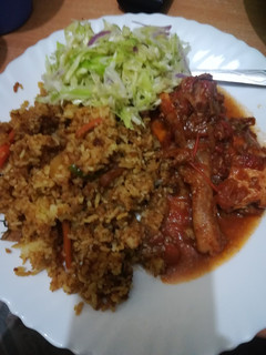 A picture of Chicken curry with stir fry rice.
