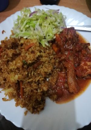 A picture of Chicken curry with stir fry rice.