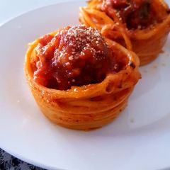 A picture of Homemade Meat Balls in Spaghetti cups.