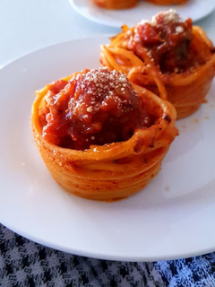 A picture of Homemade Meat Balls in Spaghetti cups.