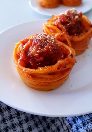 A picture of Homemade Meat Balls in Spaghetti cups.