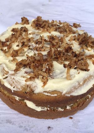 A picture of Coconut cake topped with caramelized coconut flakes.