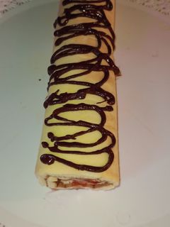 Una foto de 🍓Pionono Dulce con mermelada de frutilla y chocolate🍫