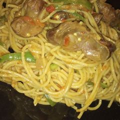 A picture of Spaghetti jollof with grilled gizzard.