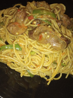 A picture of Spaghetti jollof with grilled gizzard.