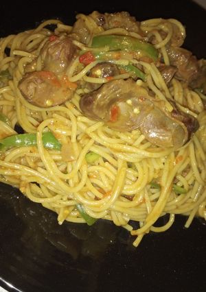 A picture of Spaghetti jollof with grilled gizzard.