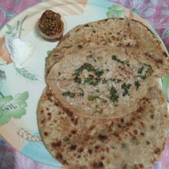 A picture of Mooli ki parathi with achar aur butter.