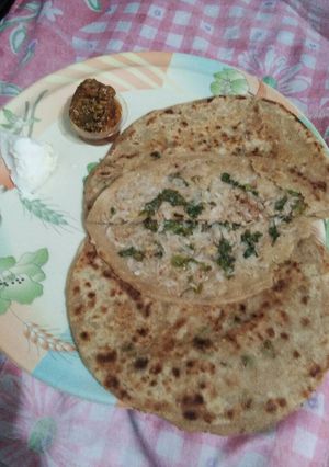 A picture of Mooli ki parathi with achar aur butter.
