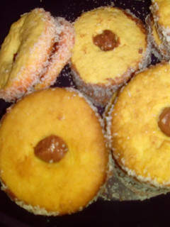 A picture of Chocolate icing tarts with coconut.