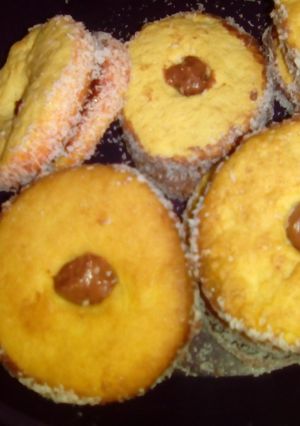 A picture of Chocolate icing tarts with coconut.