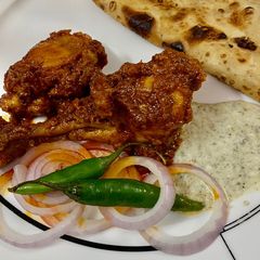A picture of Chicken Tandoori Masala with Paratha.