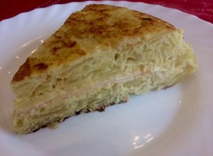 Una foto de Tortilla de papas rellena con queso y jamón