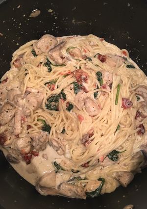 A picture of Chicken Spaghetti with Bacon, spinach, tomato, & mushrooms.