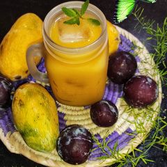 A picture of Mango Plum Peaches Mocktail 🍑🥭 🫐.