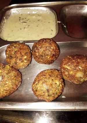 A picture of Whole moong and chana dal balls with coconut chutney.